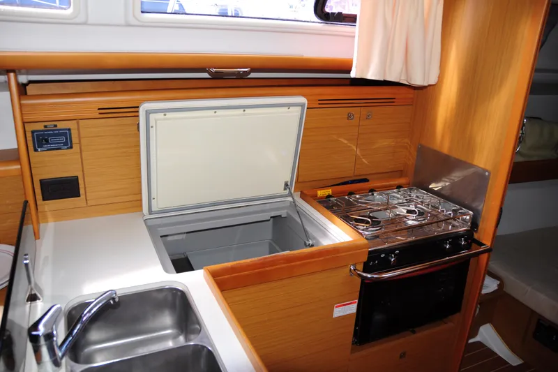 Slide: The Image of Interior of 2010 Jeanneau Sun Odyssey 36i yacht kitchen with stove, sink, and storage. - 31