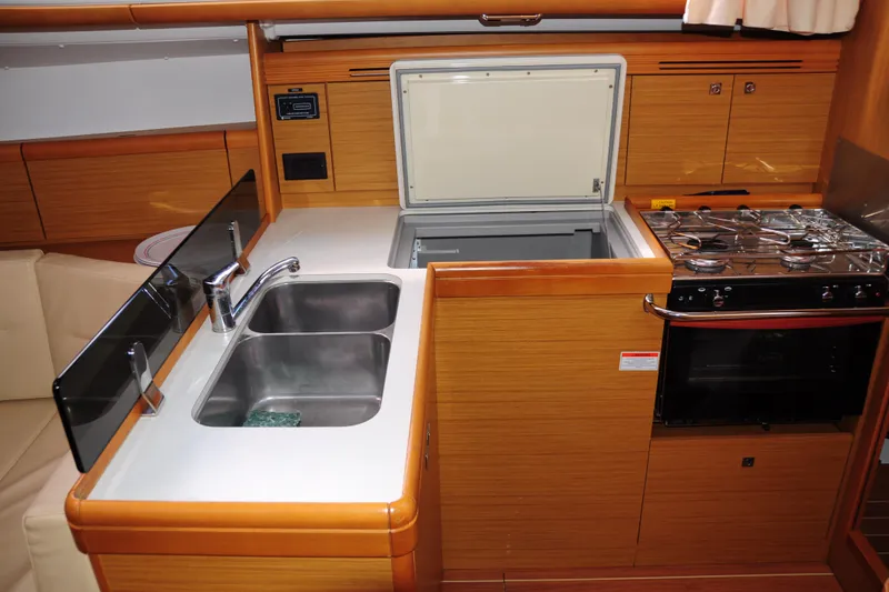 Slide: The Image of Interior view of 2010 Jeanneau Sun Odyssey 36i yacht kitchen with sink, stove, and storage. - 32
