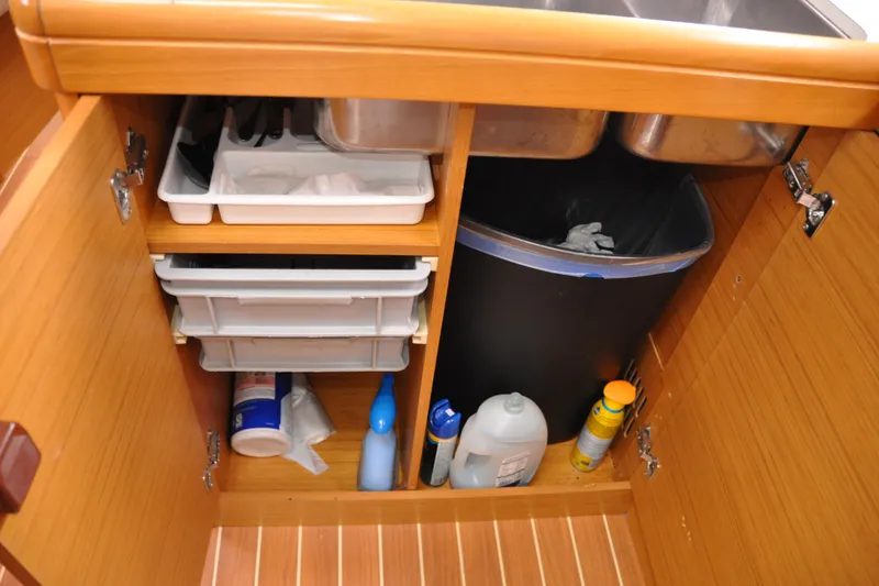 Slide: The Image of Interior storage of 2010 Jeanneau Sun Odyssey 36i yacht with cleaning supplies and trash bin. - 33