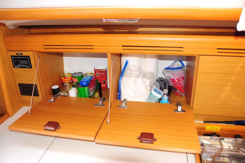 Slide: The Image of Interior storage of 2010 Jeanneau Sun Odyssey 36i yacht with supplies and canned goods. - 35