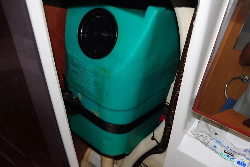 Slide: The Image of Interior view of a 2010 Jeanneau Sun Odyssey 36i sailboat, featuring a green water tank. - 47