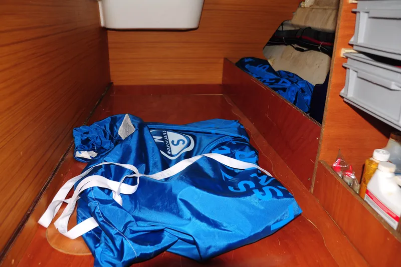 Slide: The Image of Interior storage of 2010 Jeanneau Sun Odyssey 36i with blue sail bag and supplies. - 48