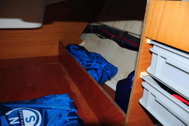 Slide: The Image of Interior storage space of 2010 Jeanneau Sun Odyssey 36i sailboat with blue bag and shelves. - 50