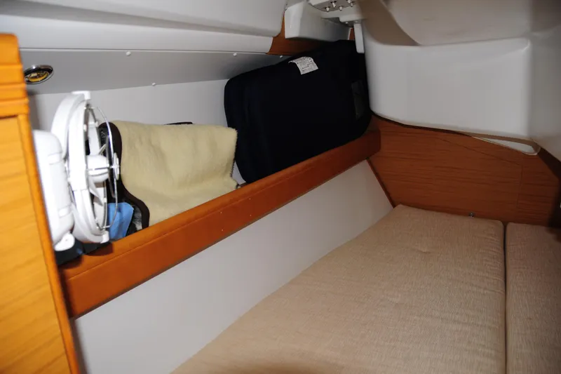 Slide: The Image of Cozy cabin interior of 2010 Jeanneau Sun Odyssey 36i sailboat with storage and fan. - 57
