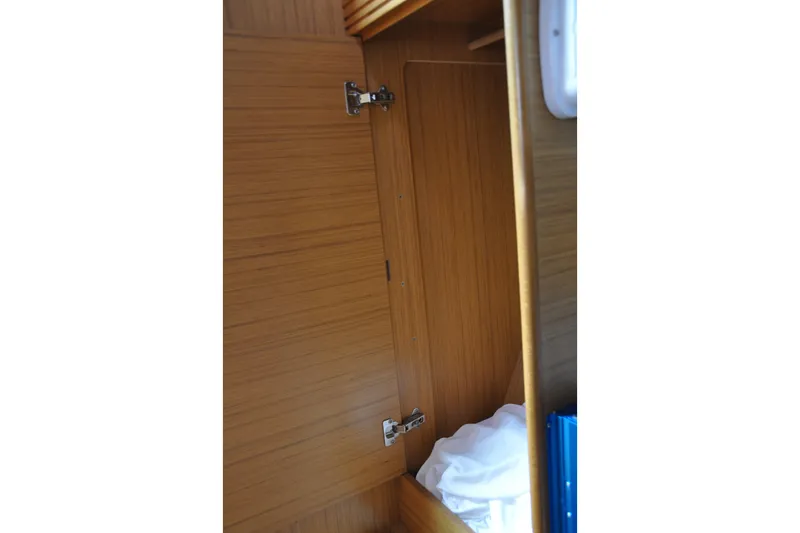 Slide: The Image of Interior wooden cabinet on a 2010 Jeanneau Sun Odyssey 36i sailboat. - 61