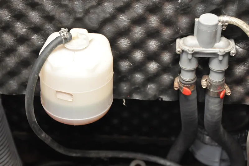 Slide: The Image of Engine compartment of 2010 Jeanneau Sun Odyssey 36i with coolant reservoir and hoses. - 73