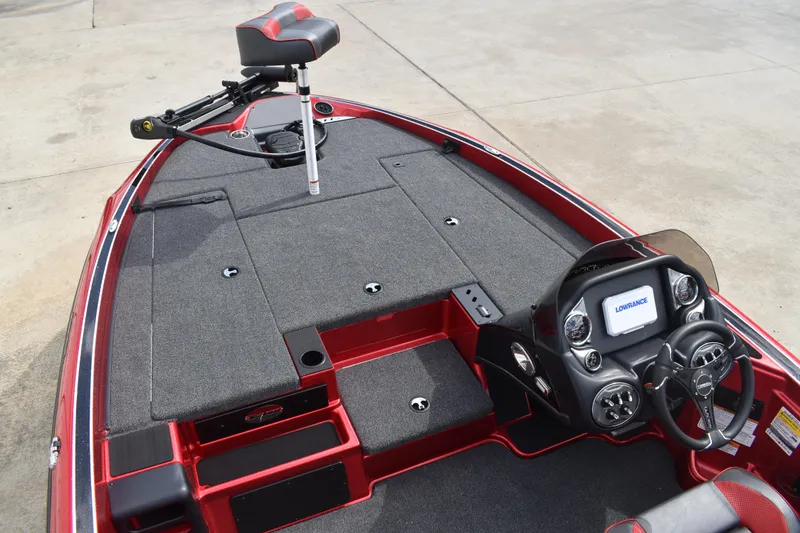 Slide: The Image of 2026 Triton 18 TrX boat interior with red and black seats, steering wheel, and storage compartments. - 10