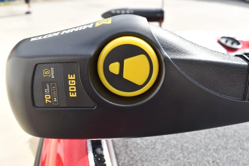 Slide: The Image of Close-up of a 2026 Triton 18 TrX boat's red metallic surface with a control knob. - 13