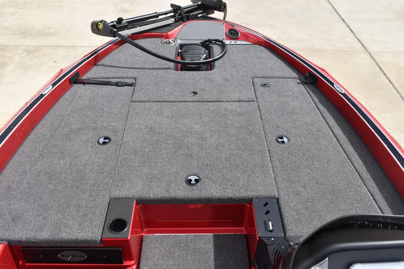 Slide: The Image of 2026 Triton 18 TrX boat interior with red and gray seats, carpeted deck. - 14