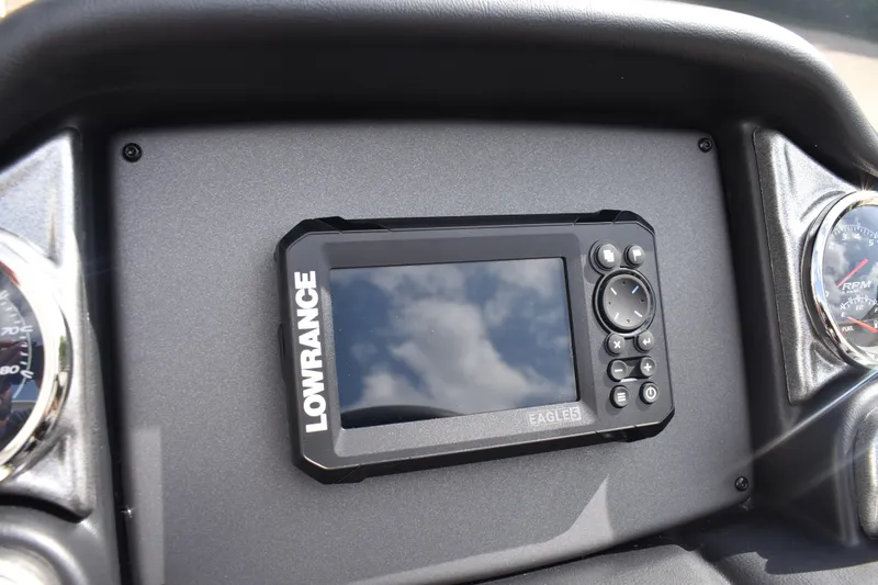 Slide: The Image of Dashboard of 2026 Triton 18 TrX boat featuring Lowrance display and gauges. - 18