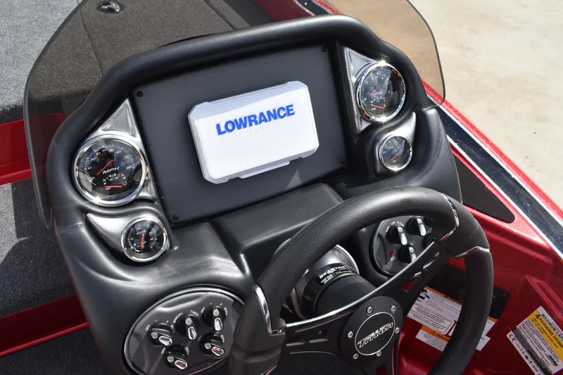 Slide: The Image of 2026 Triton 18 TrX boat interior with steering console and fishing seat. - 19