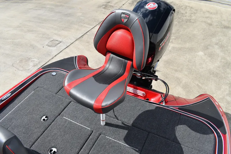 Slide: The Image of 2026 Triton 18 TrX bass boat in red, parked on a trailer outdoors. - 22