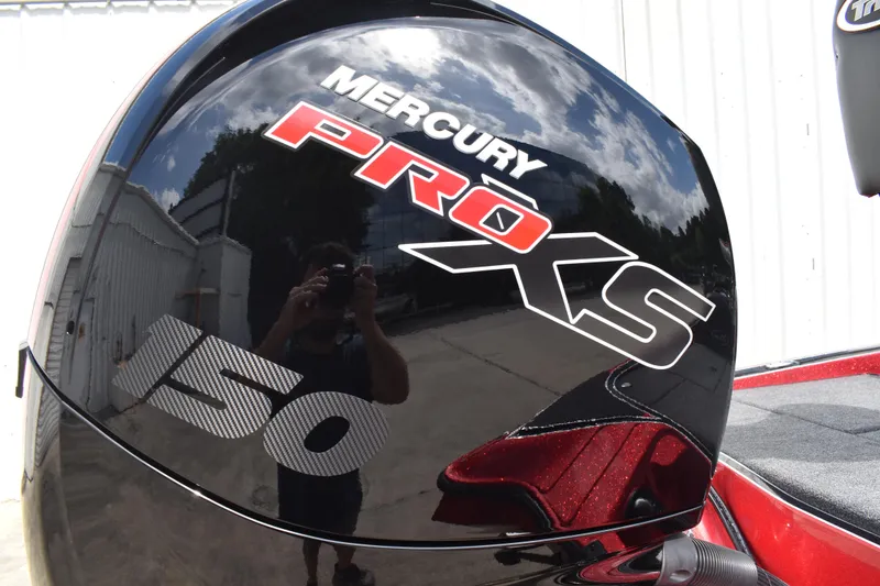 Slide: The Image of 2026 Triton 18 TrX boat deck with gray carpet and storage compartments. - 5