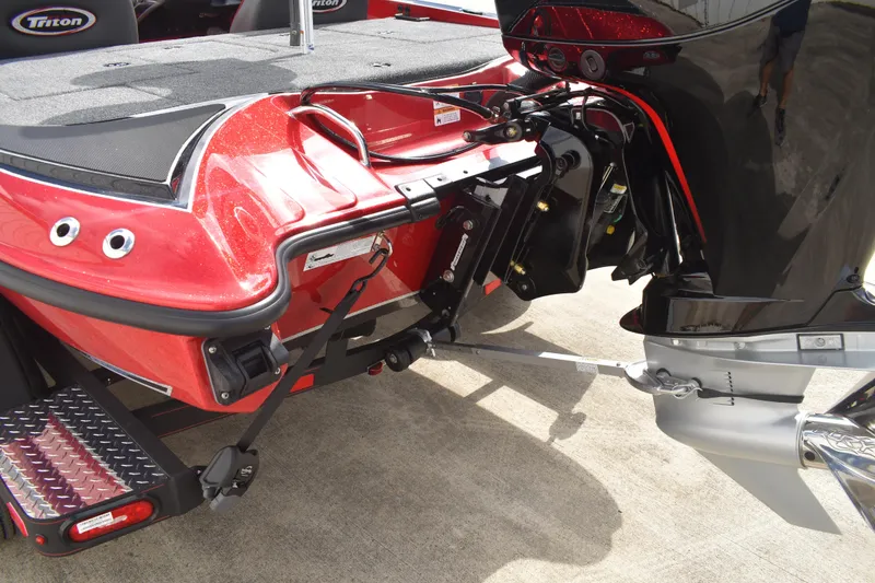 Slide: The Image of 2026 Triton 18 TrX boat interior with red accents and advanced dashboard controls. - 6
