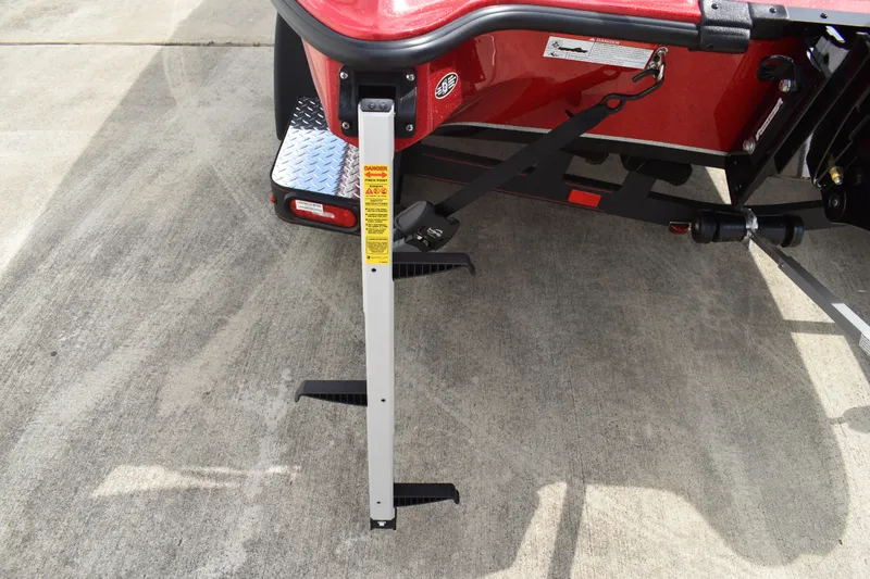 Slide: The Image of 2026 Triton 18 TrX boat deck with gray carpet and red accents. - 7