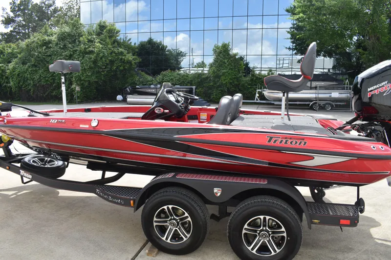 Slide: The Image of 2026 Triton 18 TrX boat seat with red and black design, featuring a powerful engine. - 8