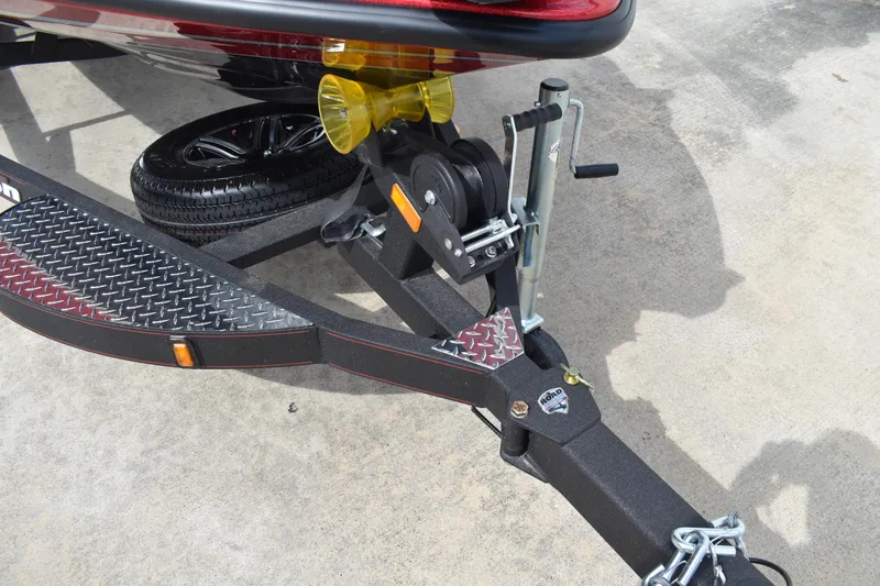 Slide: The Image of Storage compartment of 2026 Triton 18 TrX boat, featuring a red and gray interior. - 9