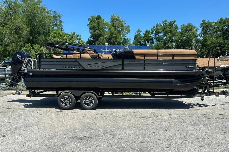 The Image of 2026 Ranger Reata 220FC pontoon boat on trailer, parked outdoors. - 1