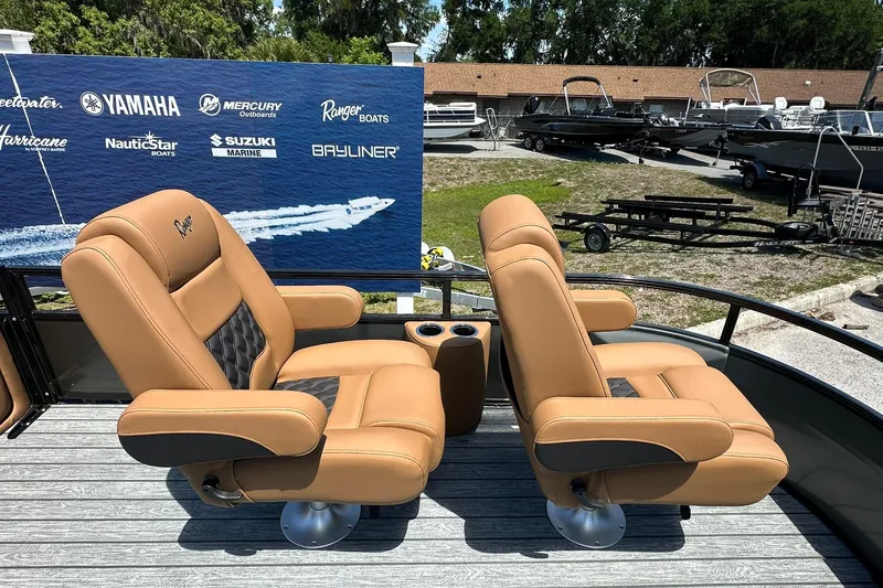 Slide: The Image of 2026 Ranger Reata 220FC boat seats with cup holders, displayed outdoors. - 10