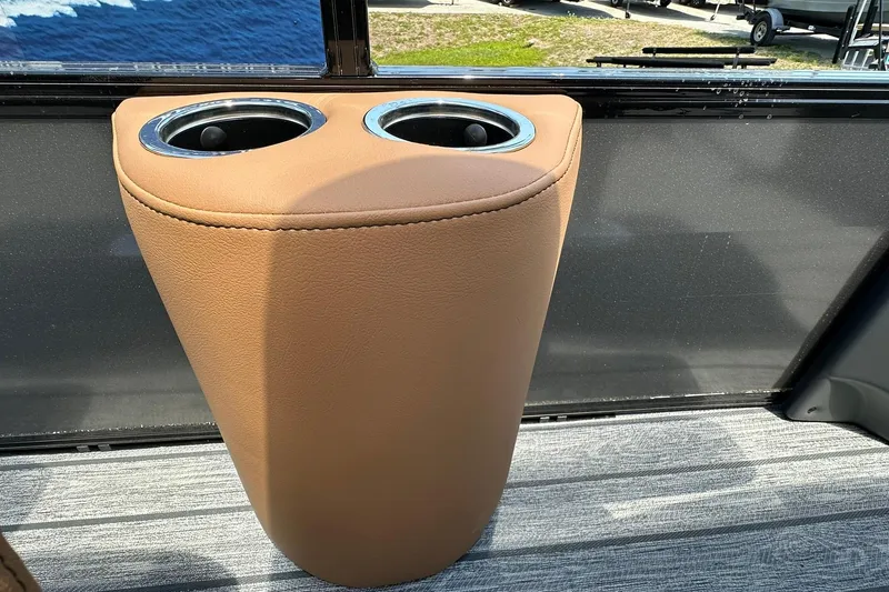 Slide: The Image of Cup holder on 2026 Ranger Reata 220FC boat, featuring tan leather finish. - 11