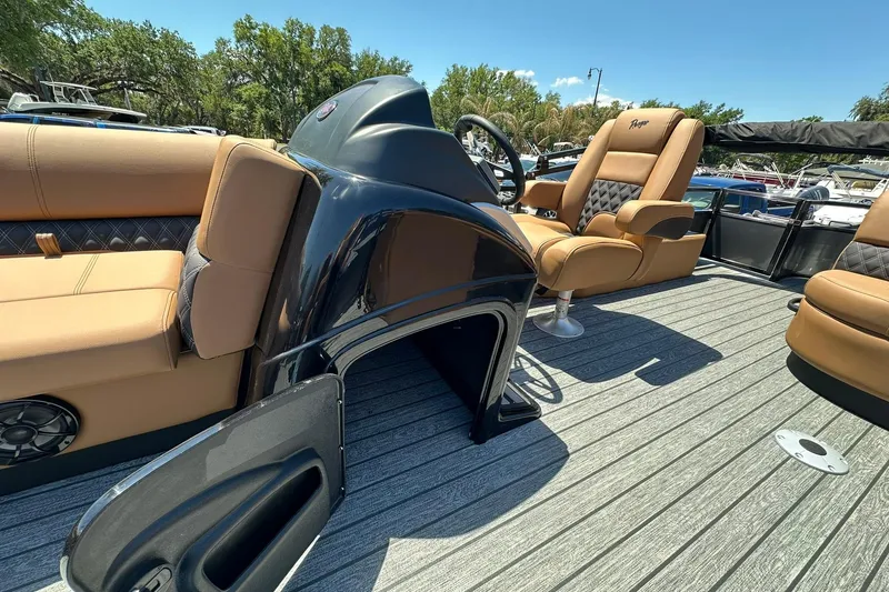 Slide: The Image of 2026 Ranger Reata 220FC boat interior with tan seating and sleek console design. - 14