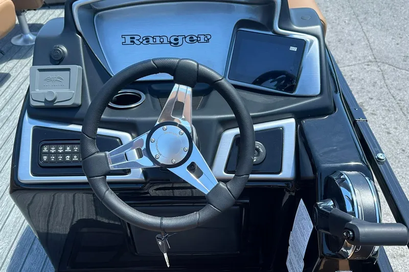 Slide: The Image of Steering console of 2026 Ranger Reata 220FC boat with modern controls and display. - 19
