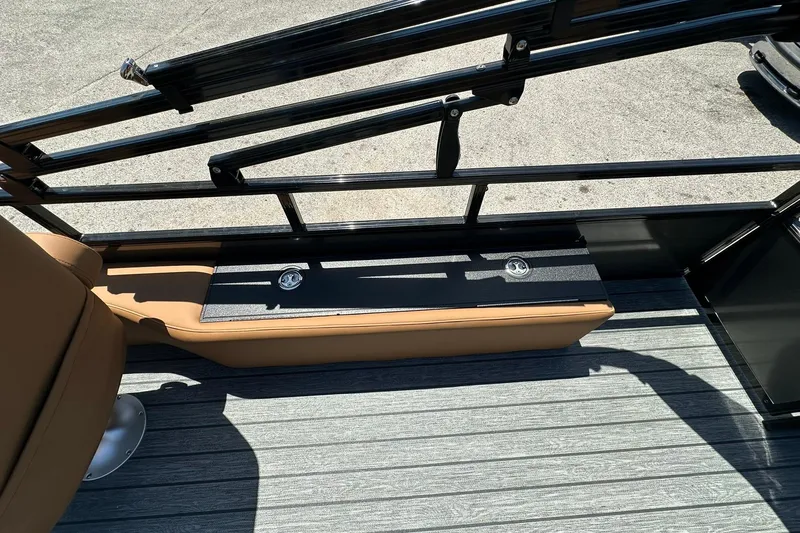 Slide: The Image of 2026 Ranger Reata 220FC boat interior with tan seating and sleek railing design. - 21