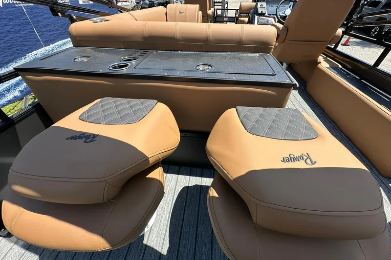 Slide: The Image of 2026 Ranger Reata 220FC boat interior with tan seating and console. - 28