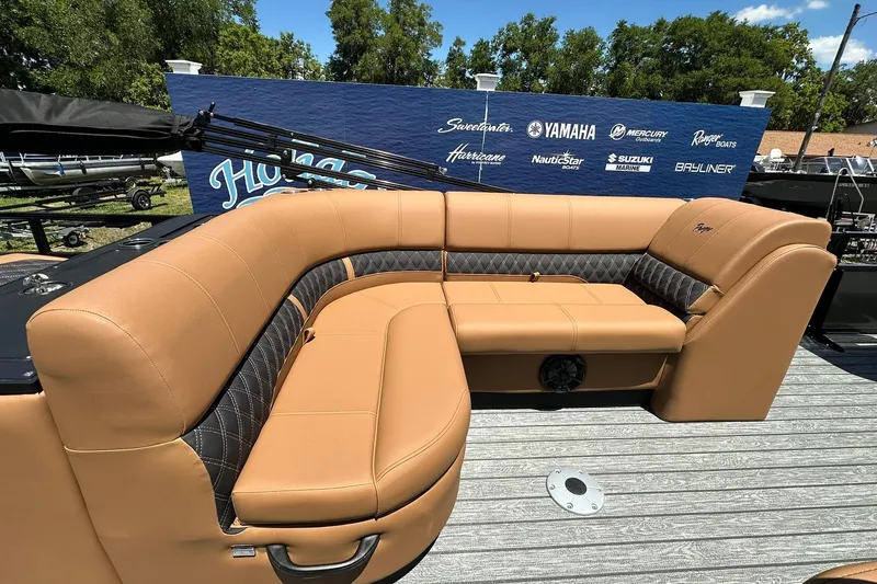 Slide: The Image of 2026 Ranger Reata 220FC boat with tan seating and stylish design on display. - 29