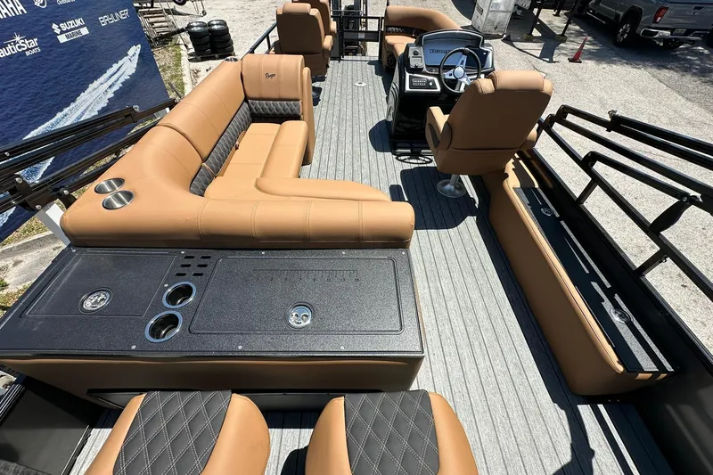 Slide: The Image of 2026 Ranger Reata 220FC boat interior with tan seating and modern helm. - 38