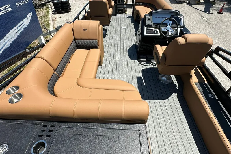 Slide: The Image of 2026 Ranger Reata 220FC boat interior with tan seating and modern steering console. - 39