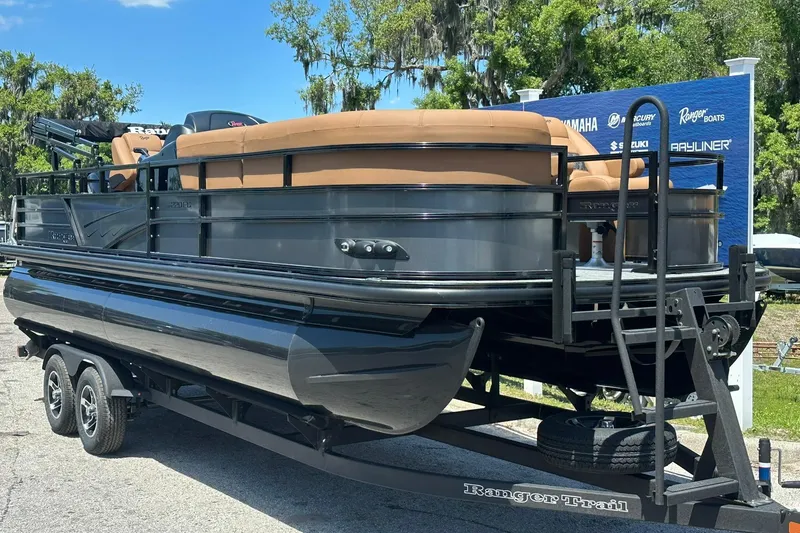 Slide: The Image of 2026 Ranger Reata 220FC pontoon boat on trailer, displayed outdoors. - 4