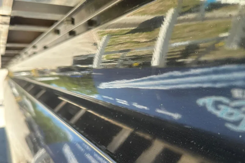 Slide: The Image of Close-up of 2026 Ranger Reata 220FC boat hull with reflective surface and sleek design. - 43