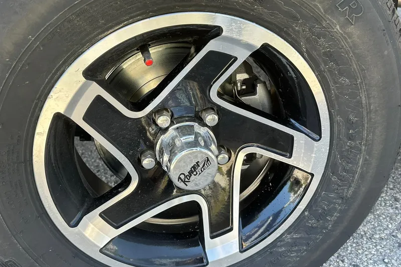 Slide: The Image of Close-up of a 2026 Ranger Reata 220FC wheel with black and silver alloy design. - 44