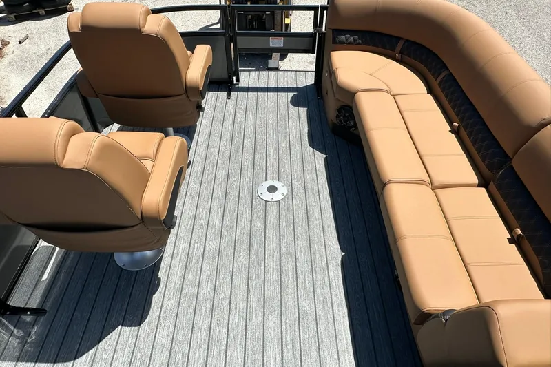 Slide: The Image of 2026 Ranger Reata 220FC boat interior with tan seating and gray flooring. - 9