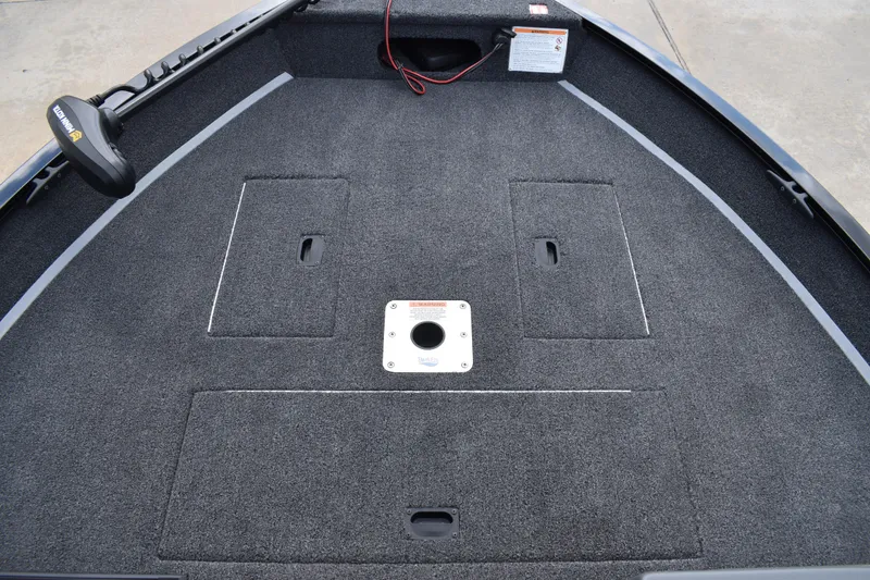 Slide: The Image of 2026 Lowe Fishing Machine 1625WT boat deck with storage compartments and carpeted surface. - 14