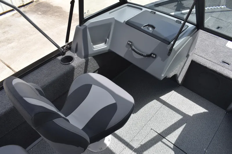 Slide: The Image of 2026 Lowe Fishing Machine 1625WT interior with seating and storage. - 19