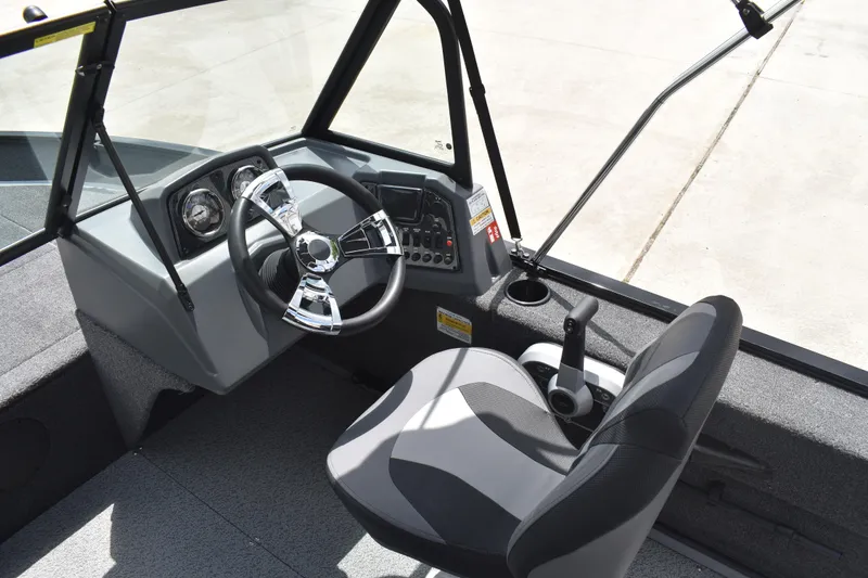 Slide: The Image of 2026 Lowe Fishing Machine 1625WT interior with steering wheel and control panel. - 21