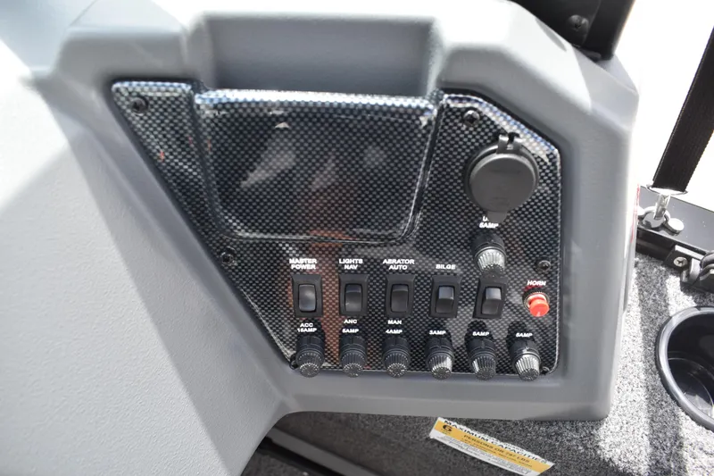Slide: The Image of Control panel of 2026 Lowe Fishing Machine 1625WT boat with switches and dials. - 23