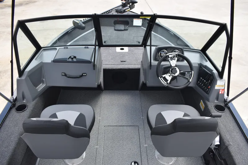 Slide: The Image of 2026 Lowe Fishing Machine 1625WT interior with dual seats and steering console. - 24