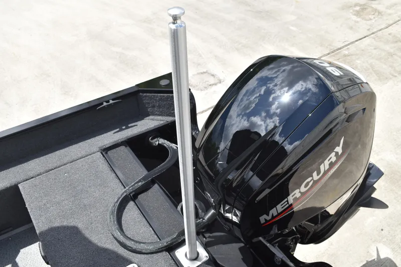Slide: The Image of 2026 Lowe Fishing Machine 1625WT with Mercury outboard motor, reflecting sky and clouds. - 30