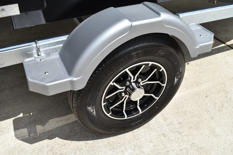 Slide: The Image of Trailer wheel and fender of 2026 Lowe Fishing Machine 1625WT on concrete surface. - 31