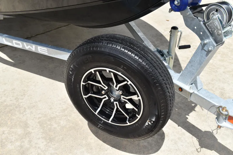 Slide: The Image of Trailer wheel of 2026 Lowe Fishing Machine 1625WT on concrete surface. - 32