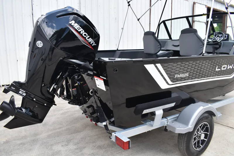 Slide: The Image of 2026 Lowe Fishing Machine 1625WT boat with Mercury outboard motor on trailer. - 4