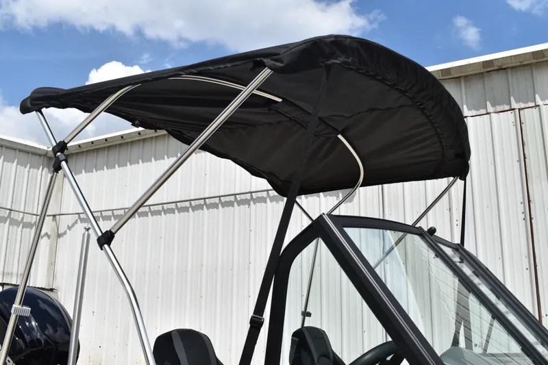 Slide: The Image of 2026 Lowe Fishing Machine 1625WT with black canopy against blue sky. - 5