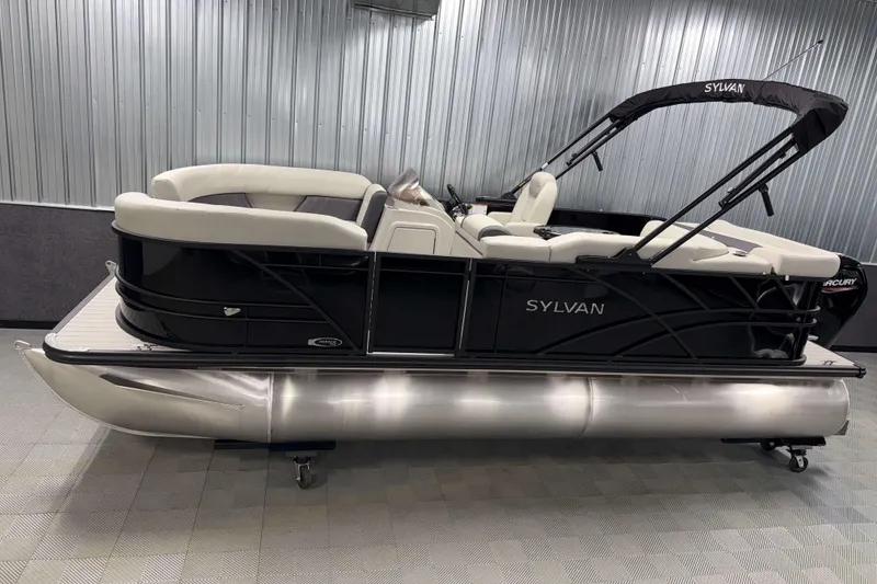 The Image of 2026 Sylvan Mirage 8520 Cruise pontoon boat in showroom, sleek black design. - 0
