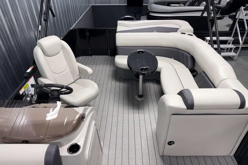 Slide: The Image of Interior of 2026 Sylvan Mirage 8520 Cruise pontoon boat with plush seating and steering console. - 13