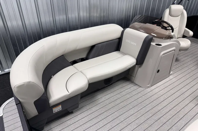 Slide: The Image of 2026 Sylvan Mirage 8520 Cruise boat interior with plush seating and modern helm. - 16