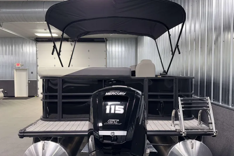 Slide: The Image of 2026 Sylvan Mirage 8520 Cruise pontoon boat with Mercury 115 engine in a garage. - 24