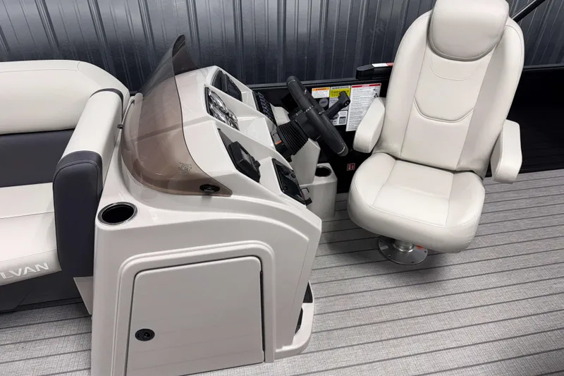 Slide: The Image of 2026 Sylvan Mirage 8520 Cruise boat interior with steering console and captain's chair. - 6